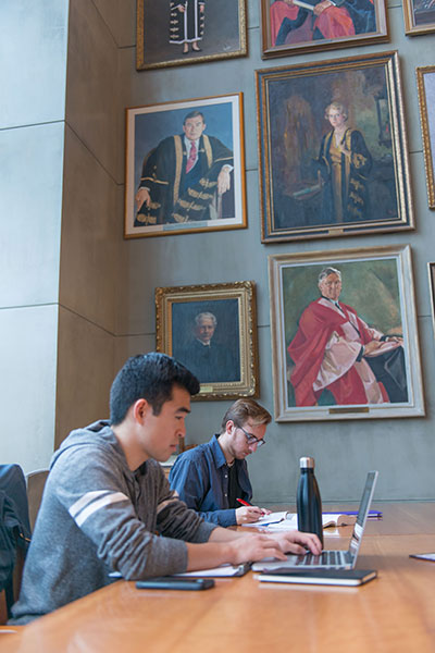 The University of British Columbia-students in campus room with pictures of past presidents
